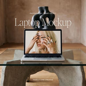May include: A laptop mockup on a glass table with a concrete base. The laptop screen displays a woman with jewelry. A black sculpture sits behind the laptop. The text "Laptop Mockup" and "AURELINE" are visible.