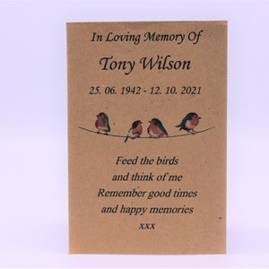 May include: A brown card with the text "In Loving Memory Of Tony Wilson 25. 06. 1942-12. 10. 2021" and a poem that reads "Feed the birds and think of me Remember good times and happy memories XXX". The card features a line of four small birds.