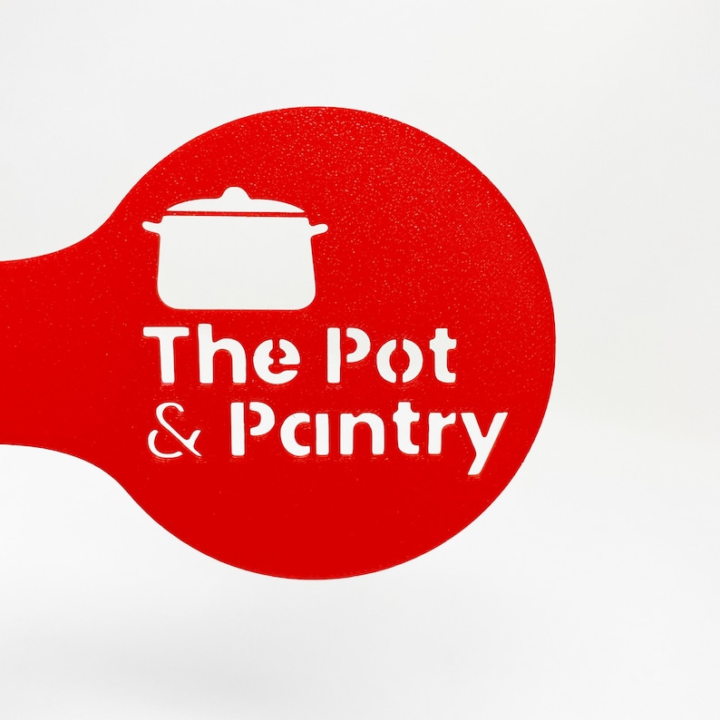 May include: Red and white stencil with the text "The Pot & Pantry" and a silhouette of a pot with a lid.