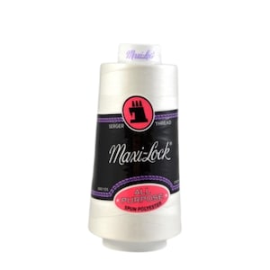 May include: A white spool of Maxi-Lock all-purpose spun polyester serger thread. The label is black with the brand name in a stylized font. A red circle with a sewing machine icon is on the label. The spool is on a white background.