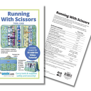 May include: A blue and green fabric tool case with the words "Running With Scissors" and "Tool Case" printed on the front. The case has pockets for scissors, markers, rotary cutters, and rulers. The case is open to show the interior pockets and compartments. The back of the case has a list of supplies needed to make the case, including fabric, zippers, and thread. The text "Running With Scissors" is also printed on the back of the case.