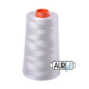 May include: A spool of silver gray thread with an orange label that says "aurifil" and a blue label that says "aurifil" with a trademark symbol.