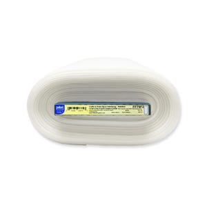 May include: A roll of white fabric interfacing, labeled "FF79F2" and "Pellon." The label also includes text about the product's use in crafts and home decor. The roll is tightly wound, showing the layers of the fabric.