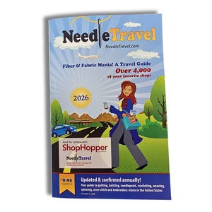 May include: A travel guide titled "Needle Travel" with the text "Fiber & Fabric Mania!" and "Over 4,000 of your favorite shops." The cover features an illustration of a woman, a car, and an airplane. The guide is for quilting, knitting, and other crafts.