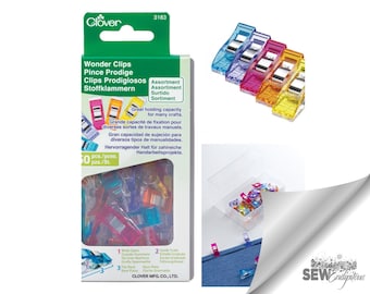 May include: A package of 50 Clover Wonder Clips featuring assorted translucent colors including blue, purple, pink, orange, and yellow. The clips have a metal spring mechanism, a flat base, and a wide opening. The packaging displays the product name, quantity, and diagrams showing the clip features.