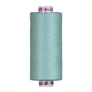 May include: A spool of light teal thread, labeled "Efil Eina Col" and "an Cotton 60". The thread is tightly wound and cylindrical, suitable for sewing and crafting projects. The spool is a soft, muted shade of teal.