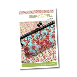 May include: A sewing pattern for a small, fabric clutch with a metal frame. The pattern is called "clutch" and is a "mini may pattern". The clutch is made of a turquoise fabric with a colorful floral design.