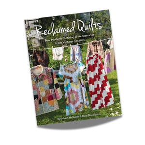 May include: Book cover with the title "Reclaimed Quilts: Sew Modern Clothing & Accessories from Vintage Textiles" by Kathleen McVeigh & Dale Donaldson. The cover features a photo of colorful patchwork clothing hanging on a clothesline.