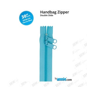 May include: A 30-inch Parrot Blue handbag zipper with a double slide. The zipper is a vibrant turquoise color and features two pull tabs. The product name and measurements are displayed in a circular label.