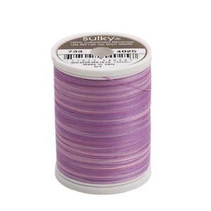May include: A spool of Sulky 100% cotton mercerized thread in a purple, pink, and white striped pattern. The spool is labeled with the number 733 and 4025. Use 90/100 top stitch needle.