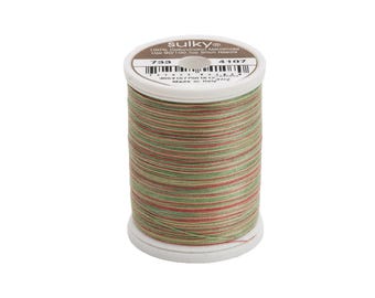 May include: A spool of Sulky 100% cotton-coated mercerized thread in shades of green, red, and brown. The spool is labeled "Sulky" and "733 4107".