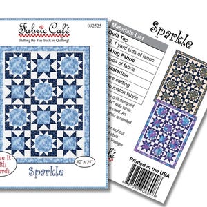 May include: A Fabric Cafe quilt pattern titled "Sparkle." The pattern features a blue and white starburst design. The quilt measures 42 x 54 inches. The package includes a materials list and states "Printed in the USA."