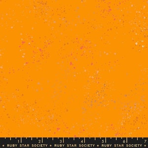 May include: Orange fabric with a speckled pattern of pink, brown, and silver dots. The fabric is a solid orange color with a subtle texture.