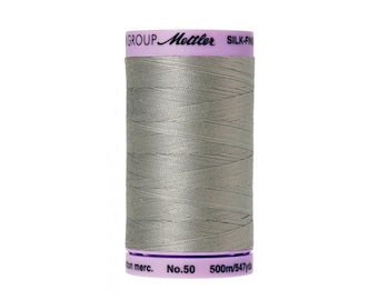 May include: A spool of gray thread with a label that reads "GROUP Mettler SILK-FINISH No.50 500m/547yd cotton merc."