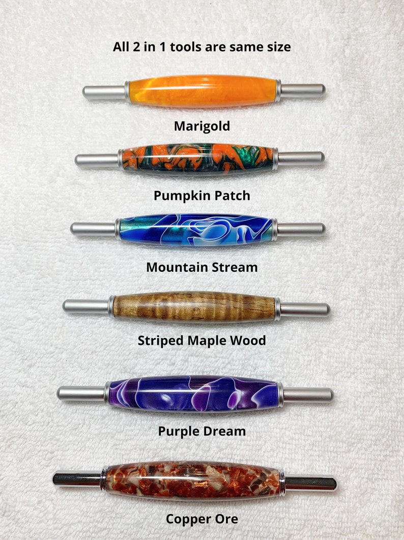 May include: Six different colored tools, each with a silver handle and a different colored handle. The tools are labeled "Marigold", "Pumpkin Patch", "Mountain Stream", "Striped Maple Wood", "Purple Dream", and "Copper Ore". All 2 in 1 tools are same size.