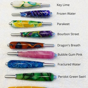 May include: Ten cylindrical handles with silver metal ends, each featuring unique marbled or solid resin patterns. The colors include pink, lime, blue, yellow, green, purple, orange, and red. Text labels identify each color pattern.