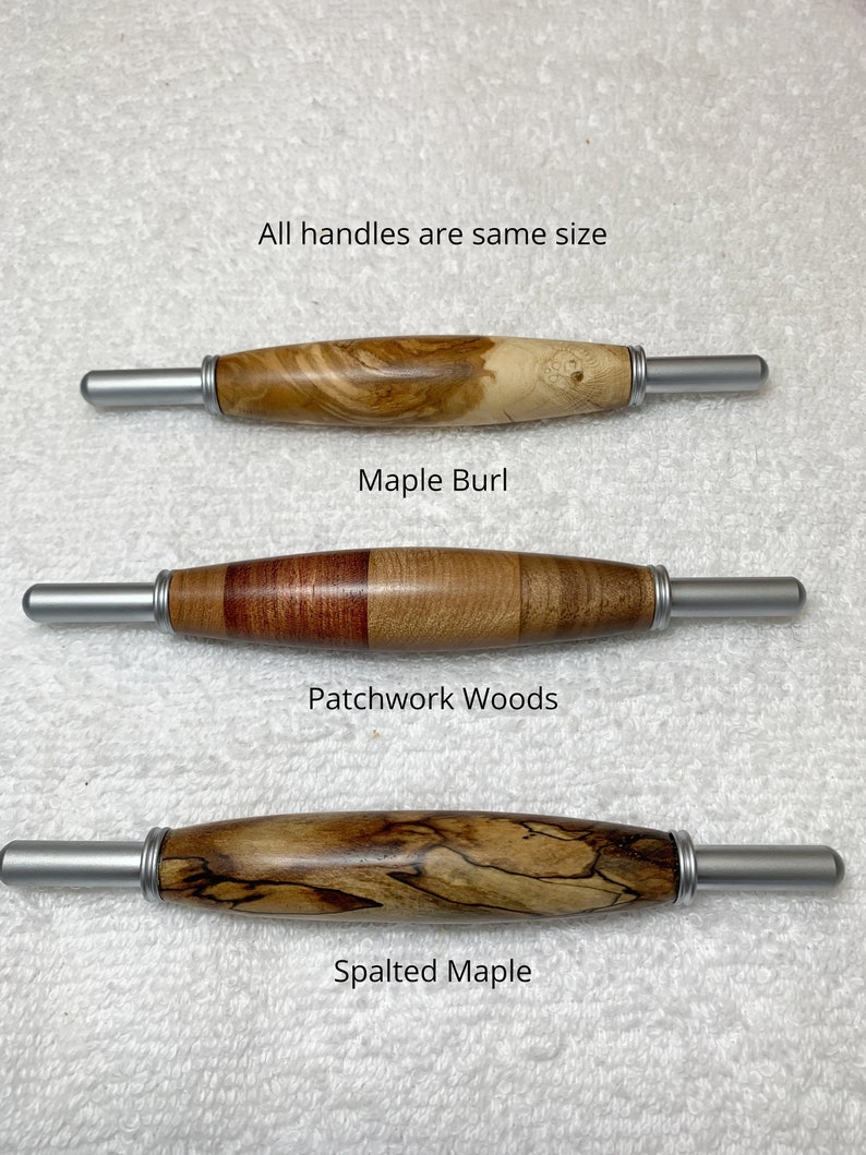 May include: Three wooden handles with silver metal ends, labeled as Maple Burl, Patchwork Woods, and Spalted Maple. The text states all handles are same size. Each handle features a distinct wood grain pattern, ranging from light swirls to dark, contrasting segments and intricate, dark, marbled lines.