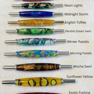 May include: Ten seam rippers with decorative resin handles in various colors and patterns, including Fire Engine Red Mesh, Neon Lights, Midnight Storm, English Toffee, Peridot Green Swirl, Winter Pastels, Morning Pastels, Mocha Swirl, Sunflower Yellow, and Exotic Fushcia.