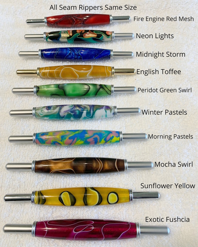 May include: Ten seam rippers with decorative resin handles in various colors and patterns, including Fire Engine Red Mesh, Neon Lights, Midnight Storm, English Toffee, Peridot Green Swirl, Winter Pastels, Morning Pastels, Mocha Swirl, Sunflower Yellow, and Exotic Fushcia.