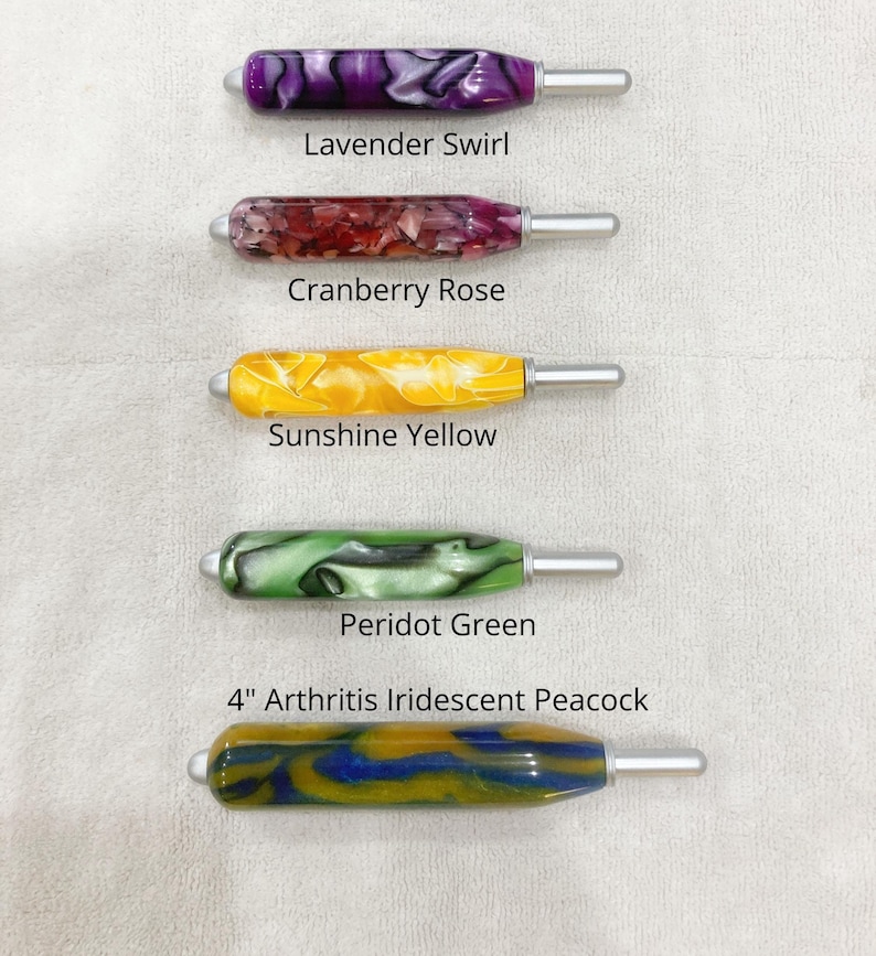 May include: Five crochet hooks with thick, ergonomic, marbled resin handles in various colors. The labels read Lavender Swirl, Cranberry Rose, Sunshine Yellow, Peridot Green, and 4" Arthritis Iridescent Peacock, each featuring a silver metal hook tip.