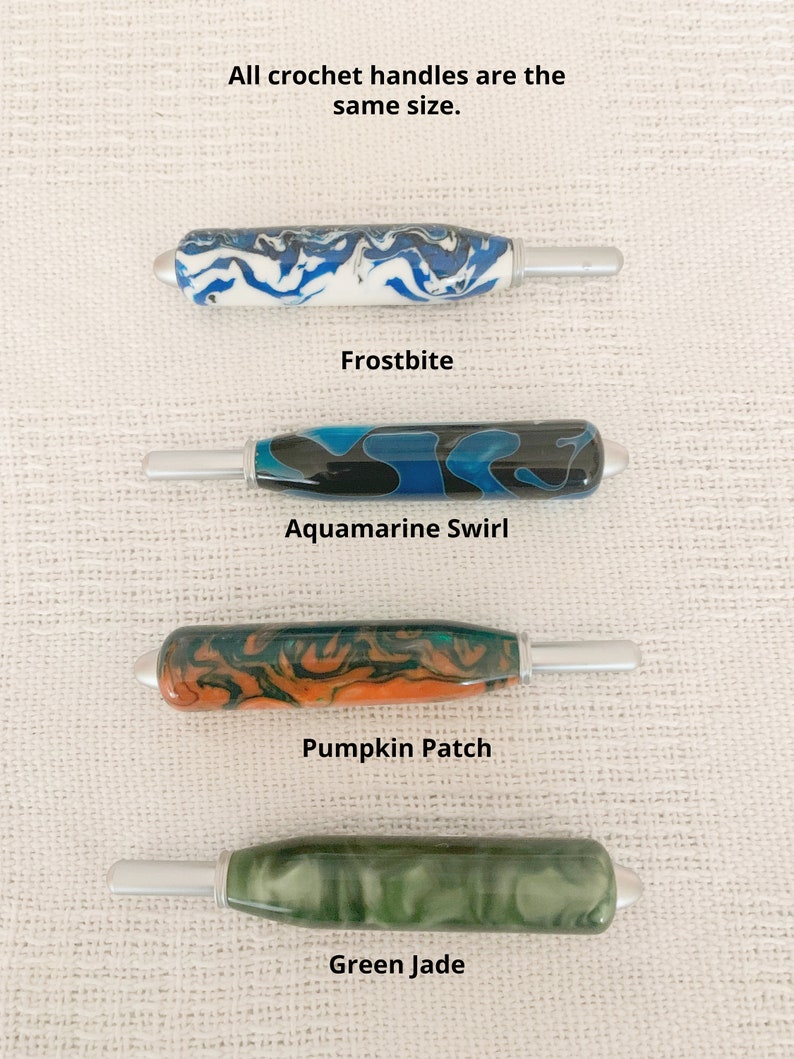 May include: Four crochet hook handles with metallic tips, labeled Frostbite in blue and white, Aquamarine Swirl in black and blue, Pumpkin Patch in orange and green, and Green Jade in solid green. Text states: All crochet handles are the same size.