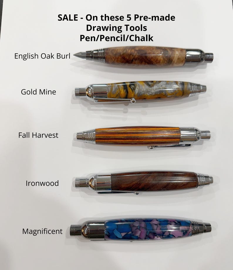 May include: Five drawing tools with chrome hardware and distinct barrels labeled English Oak Burl, Gold Mine, Fall Harvest, Ironwood, and Magnificent. The text reads: SALE - On these 5 Pre-made Drawing Tools Pen/Pencil/Chalk. Each tool has a unique finish.