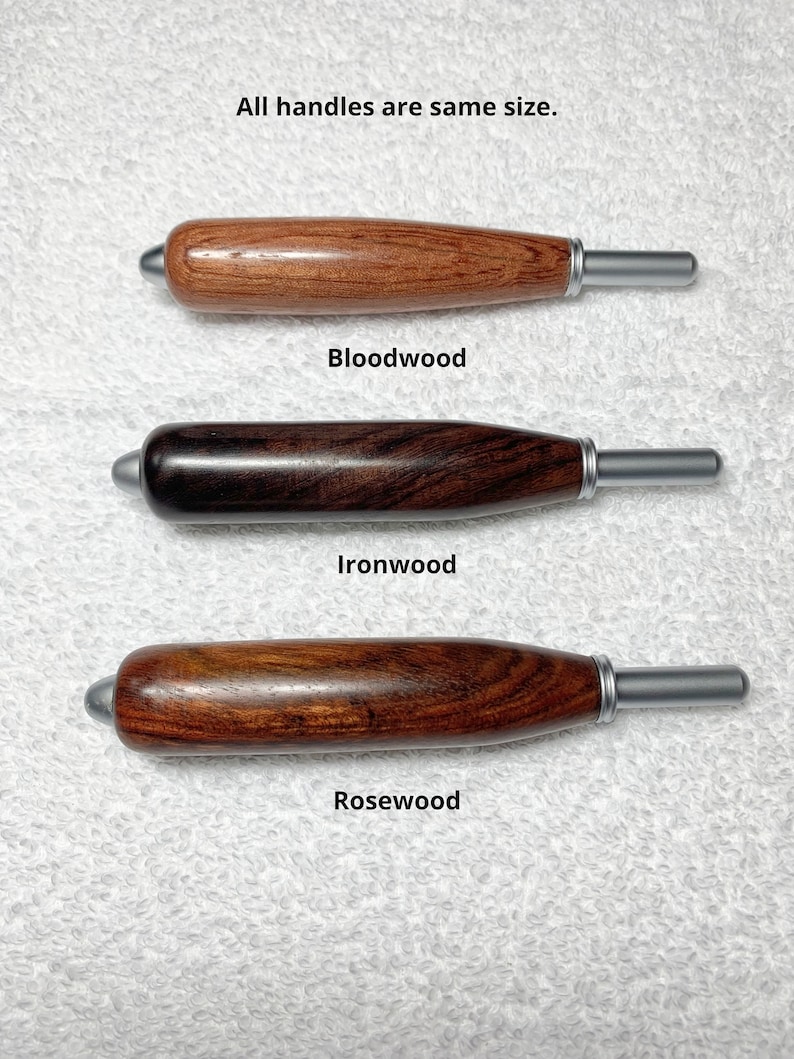 May include: Three wooden handles with metallic tips, labeled Bloodwood, Ironwood, and Rosewood. Each handle features a smooth, cylindrical shape with a rounded end and a silver-toned ferrule. The text states: All handles are same size.