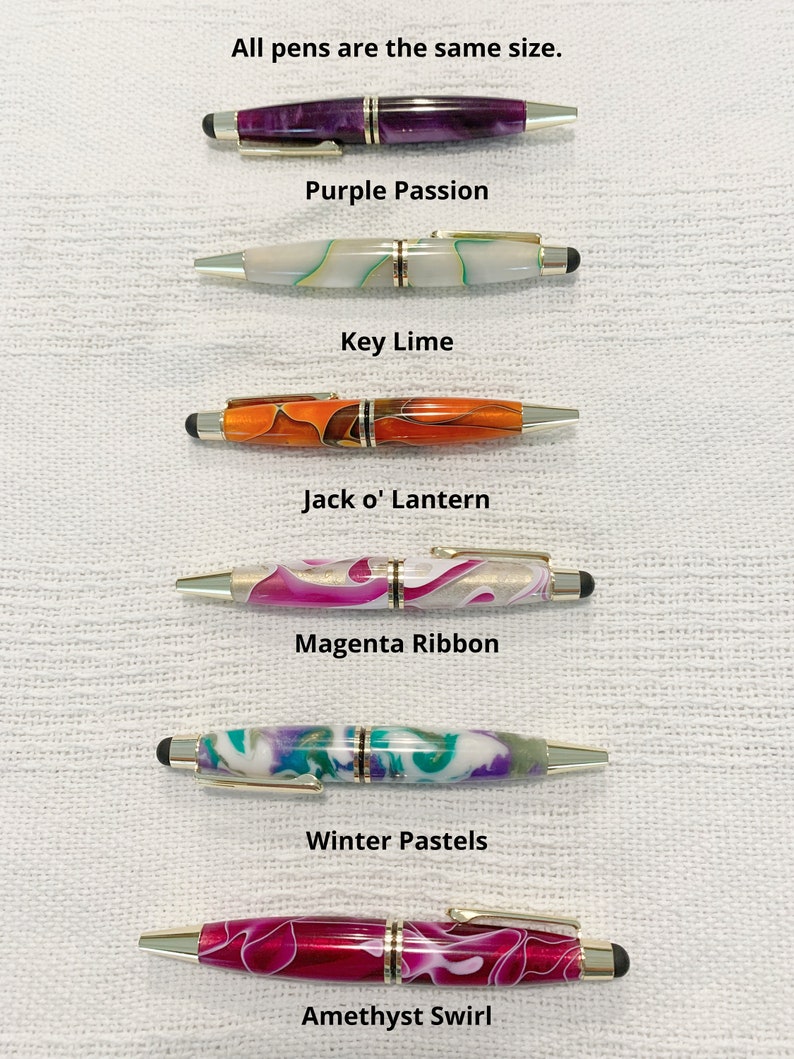 May include: Six pens with metallic accents and stylus tips, arranged vertically. The pens feature marbled patterns in purple, white with green, orange, magenta with white, multi-colored pastels, and amethyst swirl. Text labels identify each color.