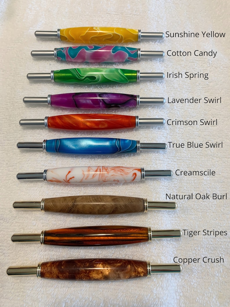 May include: Ten seam rippers with decorative handles in various colors and patterns, labeled Sunshine Yellow, Cotton Candy, Irish Spring, Lavender Swirl, Crimson Swirl, True Blue Swirl, Creamsicle, Natural Oak Burl, Tiger Stripes, and Copper Crush.