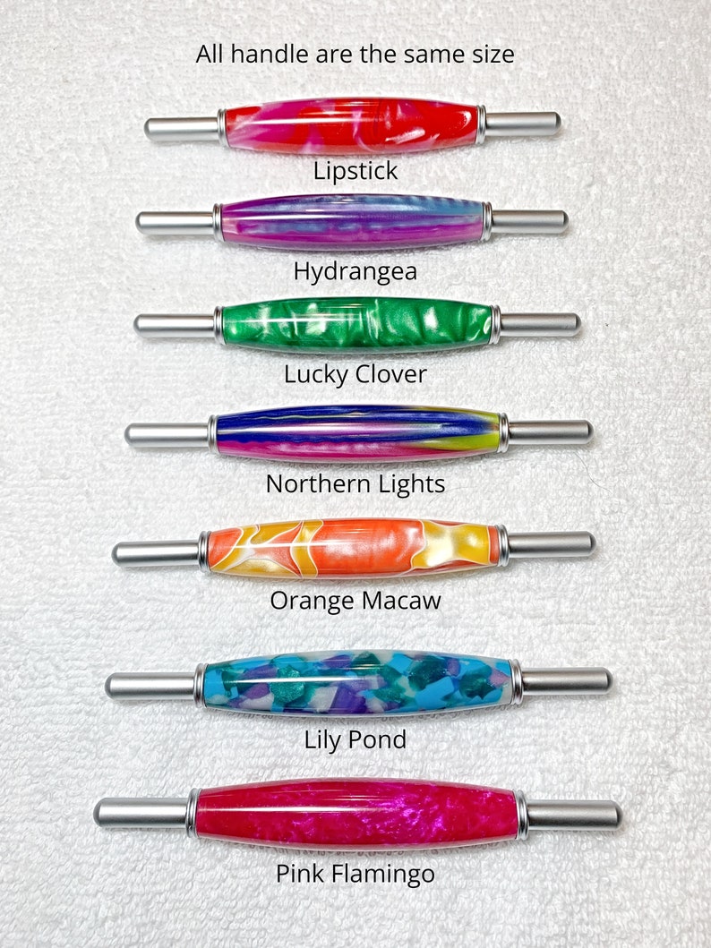 May include: Seven cylindrical handles with metallic ends, each featuring a unique acrylic pattern. The patterns are labeled as Lipstick, Hydrangea, Lucky Clover, Northern Lights, Orange Macaw, Lily Pond, and Pink Flamingo. Text states: All handle are the same size.
