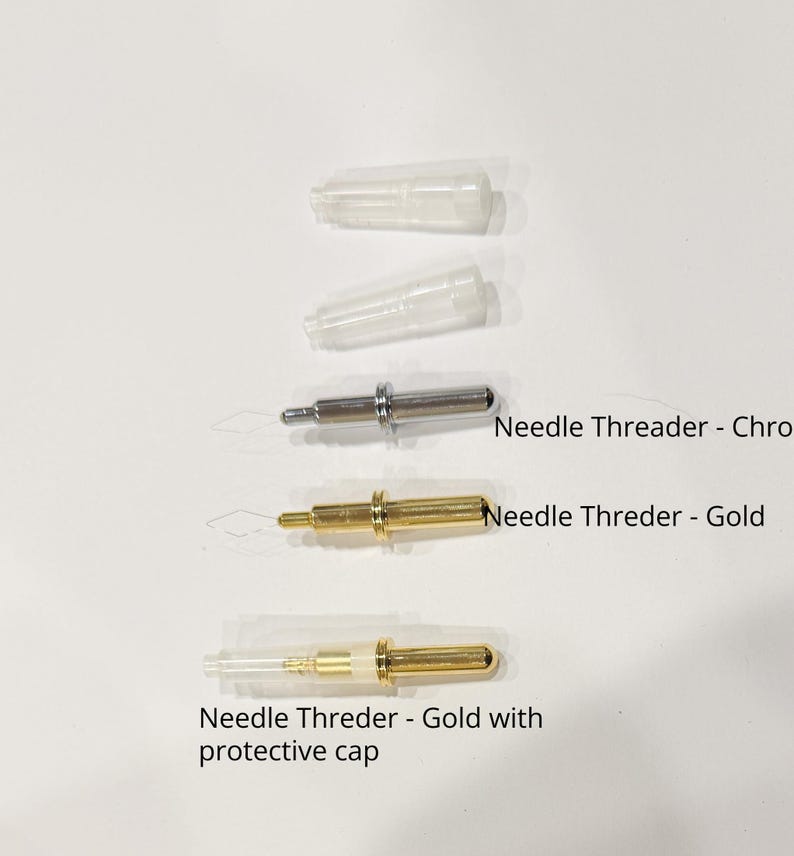 May include: An assortment of needle threaders in chrome and gold finishes, with protective caps. The image shows three threaders, one chrome and two gold, with the text "Needle Threader - Chrome", "Needle Threder - Gold", and "Needle Threder - Gold with protective cap".