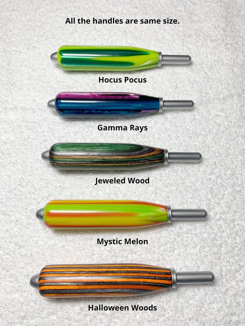 May include: Five cylindrical handles with metallic tips, labeled: Hocus Pocus (green/yellow), Gamma Rays (purple/blue), Jeweled Wood (green/brown), Mystic Melon (yellow/orange), and Halloween Woods (orange/black). Text states: All the handles are same size.