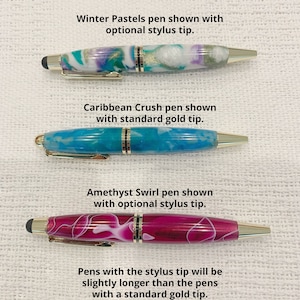 May include: Three pens with gold-tone clips and accents. The top Winter Pastels pen has a white, teal, and purple marbled barrel with a stylus tip. The middle Caribbean Crush pen has a blue marbled barrel with a gold tip. The bottom Amethyst Swirl pen has a magenta marbled barrel with a stylus tip.