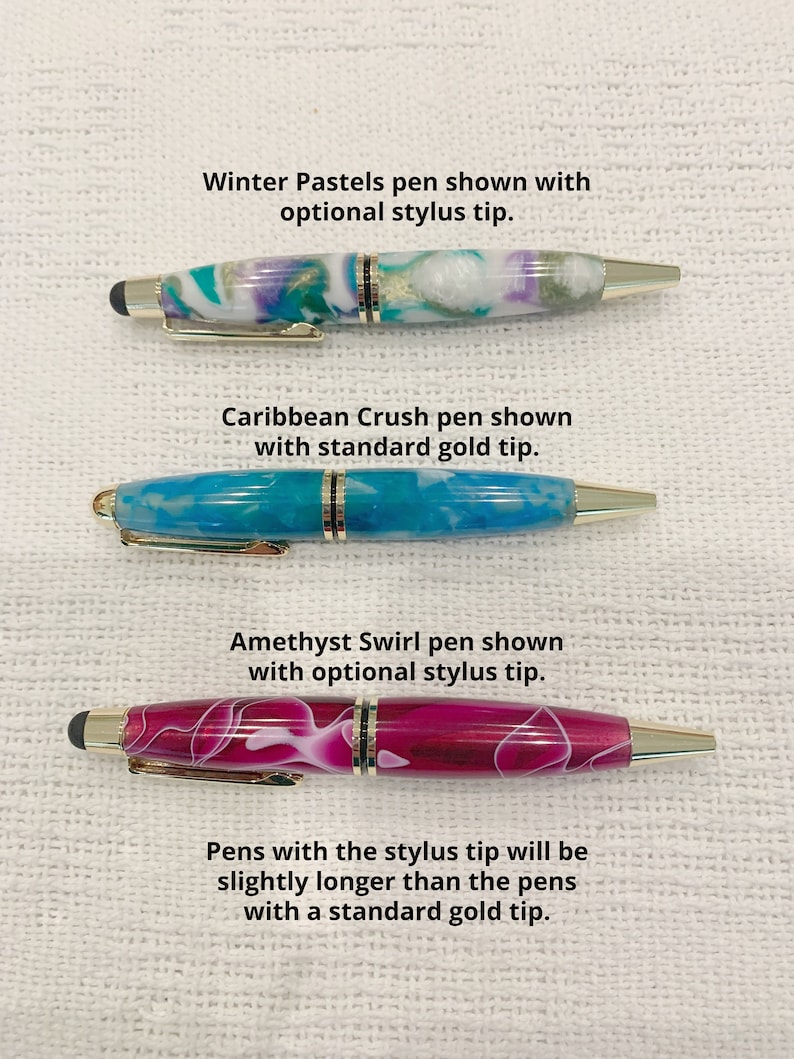 May include: Three pens with gold-tone clips and accents. The top Winter Pastels pen has a white, teal, and purple marbled barrel with a stylus tip. The middle Caribbean Crush pen has a blue marbled barrel with a gold tip. The bottom Amethyst Swirl pen has a magenta marbled barrel with a stylus tip.