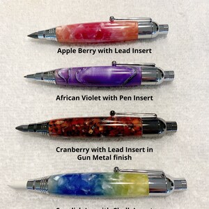 May include: Four 3 in 1 Marking Tools with chrome or gun metal hardware. The first is Apple Berry with a lead insert, the second is African Violet with a pen insert, the third is Cranberry with a lead insert, and the fourth is Swedish Ice with a chalk insert.