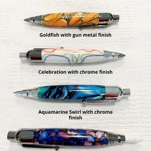 May include: Four 3 in 1 marking tools with distinct barrels. Top: Goldfish pattern with gun metal finish. Second: Celebration pattern with chrome finish. Third: Aquamarine Swirl pattern with chrome finish. Bottom: Maleficient pattern with gun metal finish.