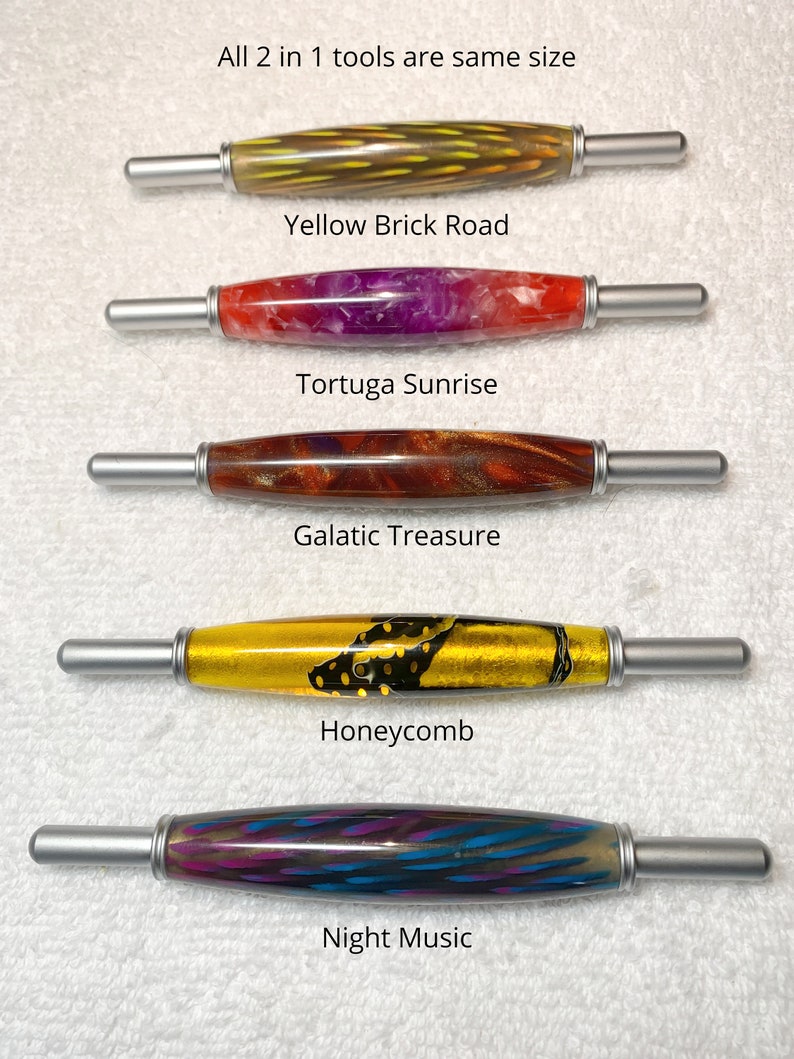 May include: Five 2-in-1 tools with cylindrical barrels and silver metal ends. The barrels feature distinct patterns: Yellow Brick Road, Tortuga Sunrise, Galatic Treasure, Honeycomb, and Night Music. Text labels identify each tool by name.