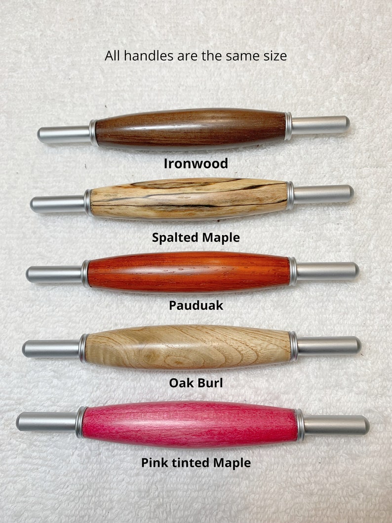 May include: Five wooden handles with silver metal ends. The handles are made of different types of wood: ironwood, spalted maple, pauduak, oak burl, and pink tinted maple. All handles are the same size. "All handles are the same size" is written at the top of the image.