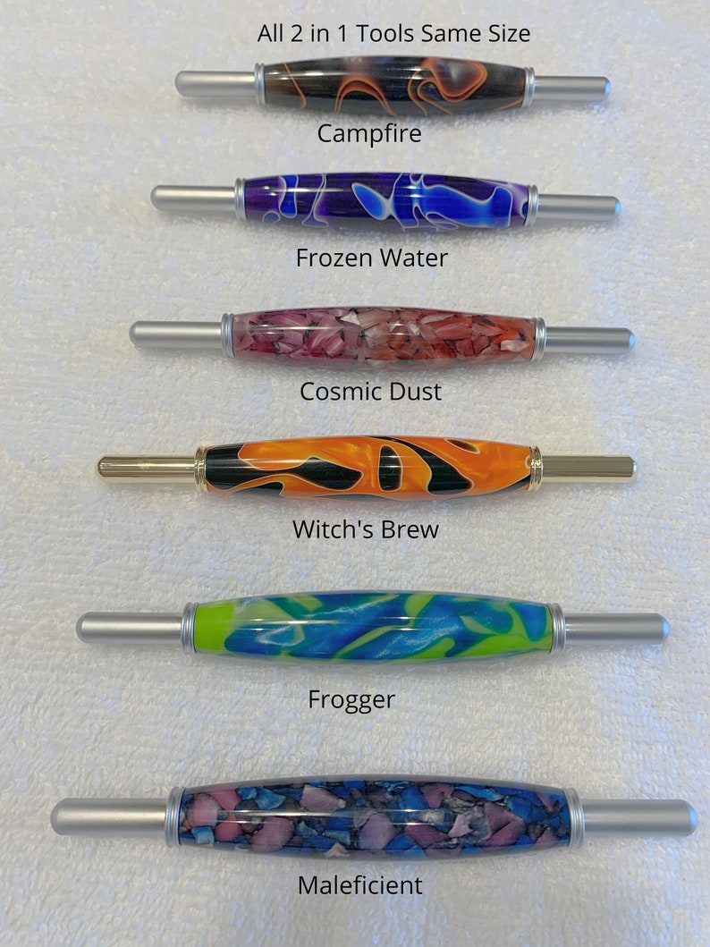 May include: Six different colorful crochet hooks with silver handles. The hooks are labeled "Campfire", "Frozen Water", "Cosmic Dust", "Witch's Brew", "Frogger", and "Maleficent". All 2 in 1 Tools Same Size.