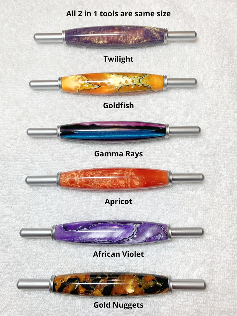 May include: Six 2-in-1 tools with metallic ends and decorative resin barrels in various colors labeled Twilight, Goldfish, Gamma Rays, Apricot, African Violet, and Gold Nuggets. The text states: All 2 in 1 tools are same size.