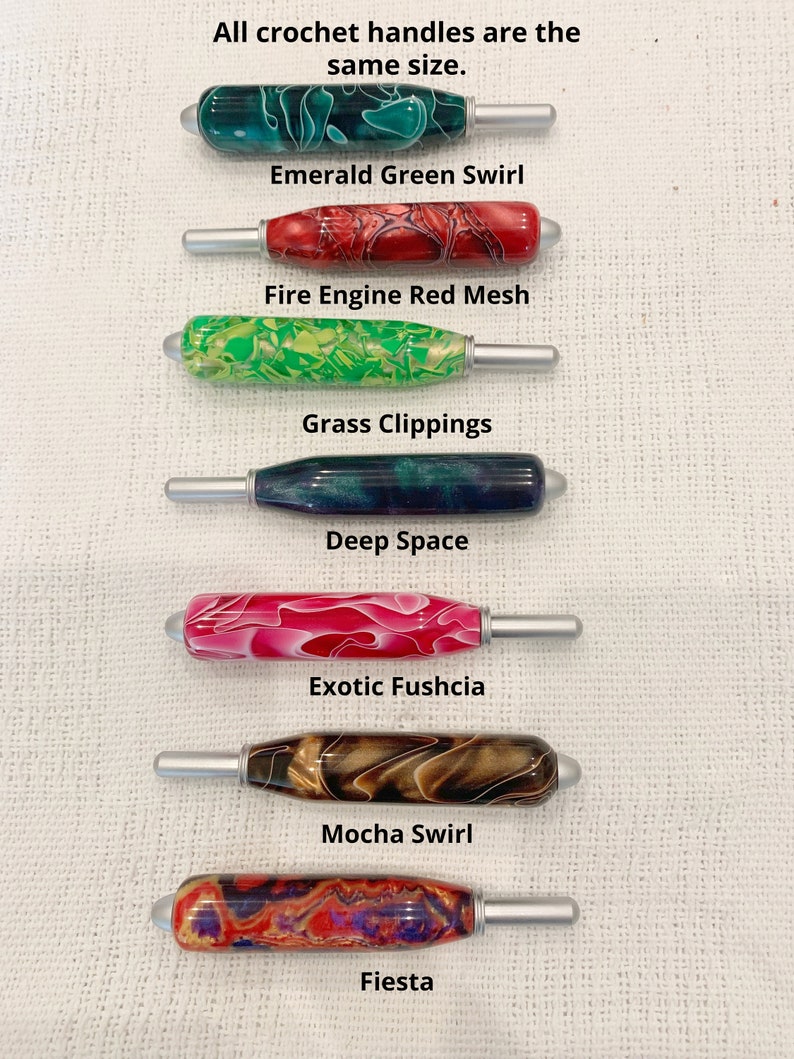 May include: Seven crochet hook handles with silver metal tips, each featuring a unique resin pattern: Emerald Green Swirl, Fire Engine Red Mesh, Grass Clippings, Deep Space, Exotic Fuchsia, Mocha Swirl, and Fiesta. All crochet handles are the same size.