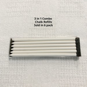 May include: A set of six white chalk refills arranged horizontally in a clear plastic case with black foam ends. The text 3 in 1 Combo Chalk Refills Sold in 6 pack is printed above the container. The chalk sticks are cylindrical and pointed.