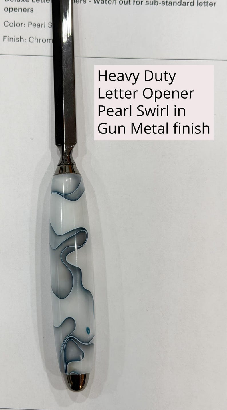 May include: A heavy duty letter opener with a metallic blade and a handle featuring a white and gray pearl swirl pattern. The text on the image reads: Heavy Duty Letter Opener Pearl Swirl in Gun Metal finish. The design includes a smooth, rounded handle.