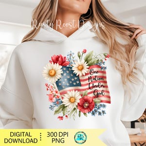 May include: White hoodie featuring a floral American flag design with the text "One Nation Under God." The design includes red, white, and blue flowers and the flag's stars and stripes. The hoodie has a drawstring hood.