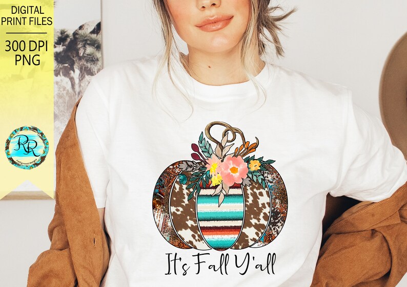 May include: A white t-shirt with a colorful patchwork pumpkin design and the text "It's Fall Y'all".
