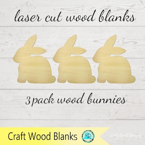 May include: Three laser-cut wood bunny blanks. The bunnies are light-colored wood and are in a sitting position. The text "laser cut wood blanks" and "3 pack wood bunnies" are written in black script.