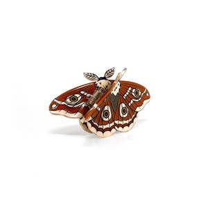 "Unique hair clip combining Lunar Moth and Death's Head Moth designs, perfect for a gothic look."
