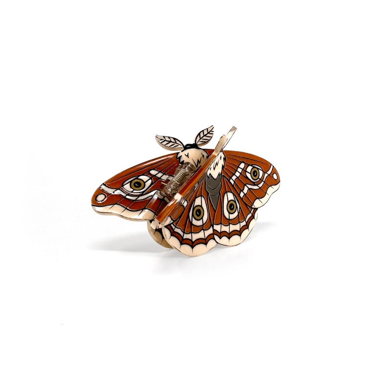 "Unique hair clip combining Lunar Moth and Death's Head Moth designs, perfect for a gothic look."