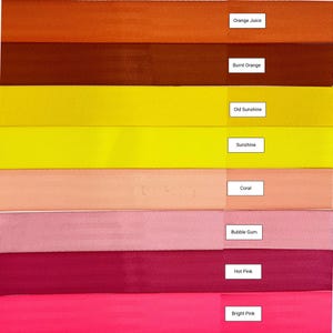 May include: A collection of eight fabric ribbon samples in various shades of orange, yellow, pink, and red. The colors are labeled from top to bottom: Orange Juice, Burnt Orange, Old Sunshine, Sunshine, Coral, Bubble Gum, Hot Pink, and Bright Pink.