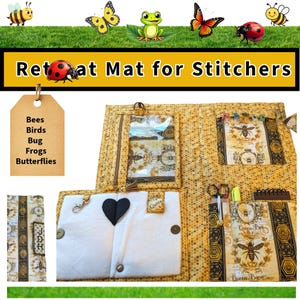 May include: A yellow quilted retreat mat for stitchers, featuring bee and honeycomb patterns. The mat has multiple pockets and compartments, including a clear zippered pouch and a white flap with a black heart. The mat also has a tag with the words "Bees, Birds, Bug, Frogs, Butterflies".